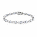 Pear-cut moissanite tennis bracelet laid flat with its box clasp