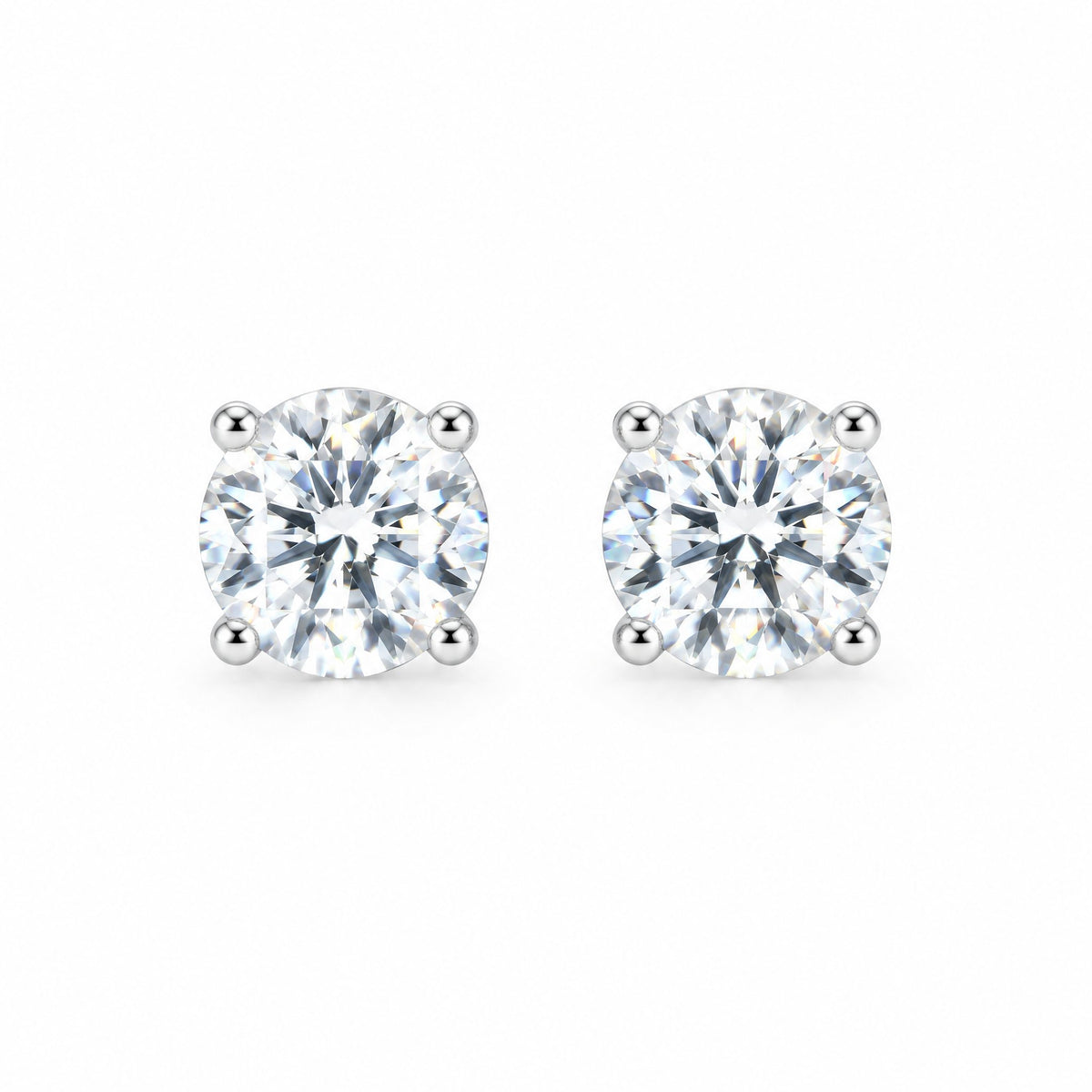 Pair of round moissanite stud earrings in four-prong settings