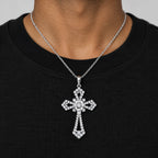 Man in a black T-shirt wearing the statement cross pendant