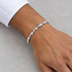 Man wearing the pear-cut tennis bracelet below a white shirt cuff