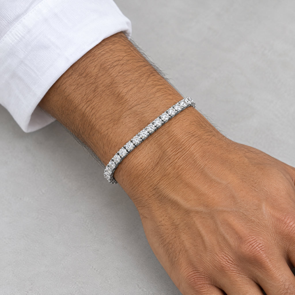 Man wearing a 4mm tennis bracelet below a white shirt cuff
