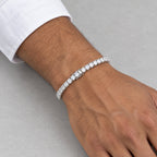 Man wearing a 5mm tennis bracelet below a white shirt cuff