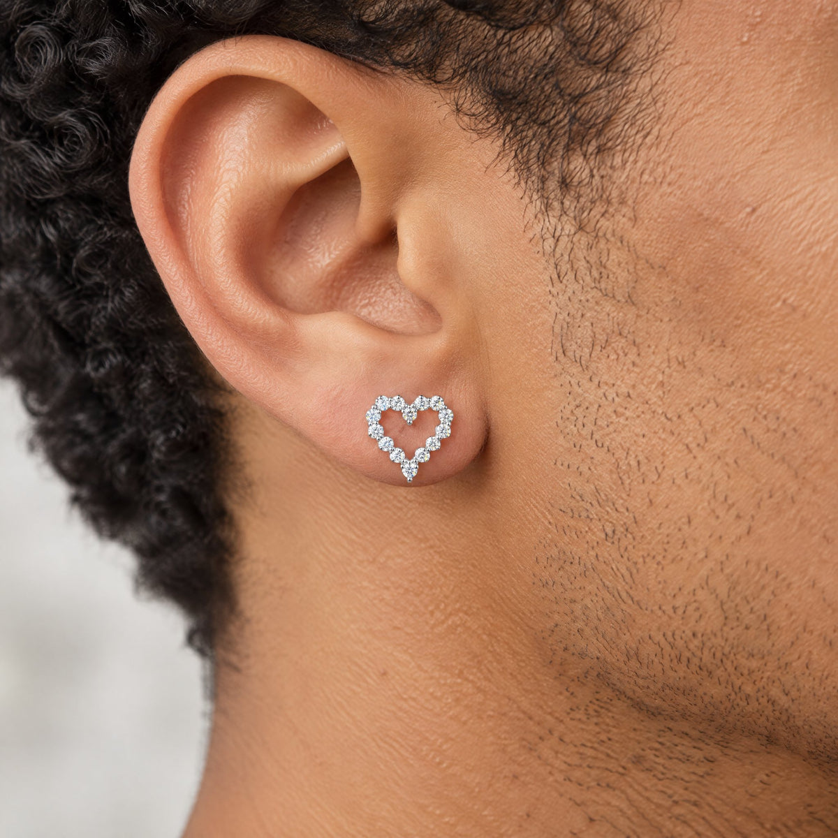 Heart outline earring worn on the earlobe