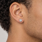 Round solitaire stud earring worn on the earlobe