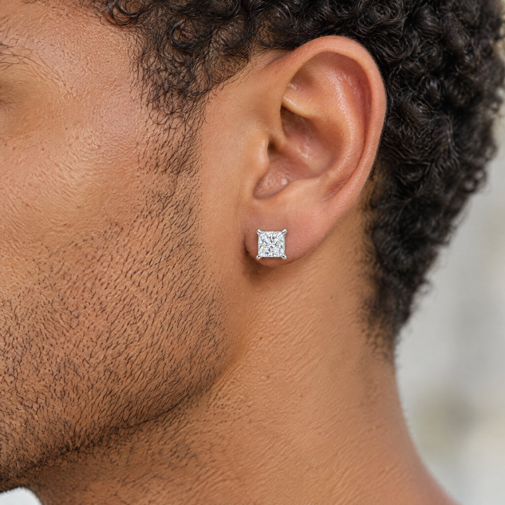 Princess-cut moissanite stud earring worn on the earlobe