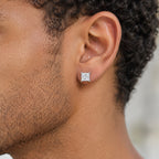Princess-cut moissanite stud earring worn on the earlobe