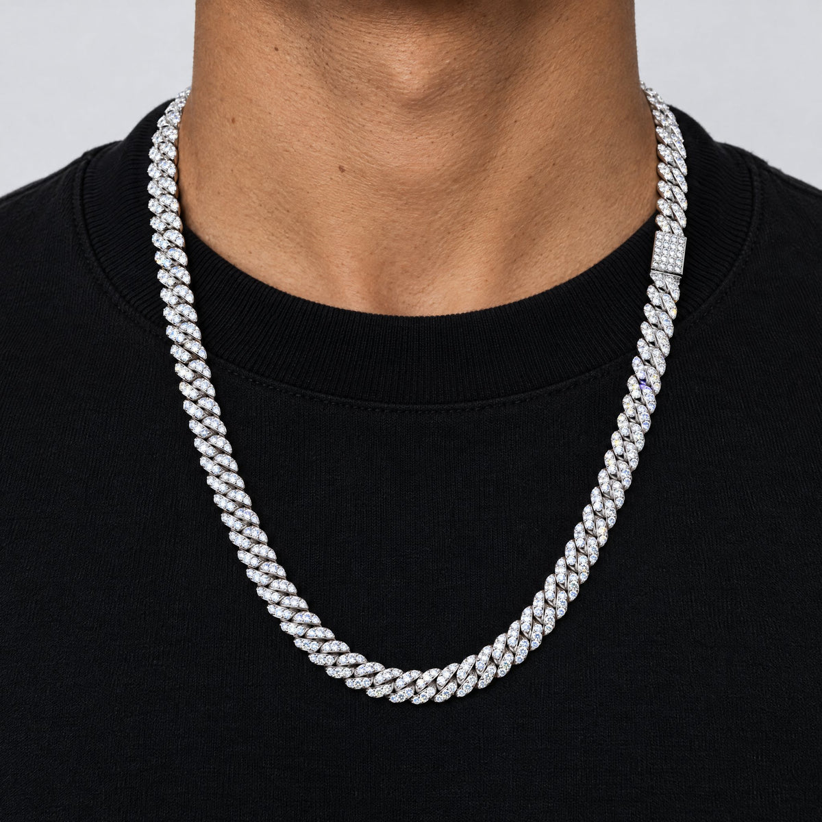 Man in a black T-shirt wearing an 8mm iced Cuban link chain