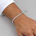 Man wearing the adjustable tennis bracelet below a white shirt cuff