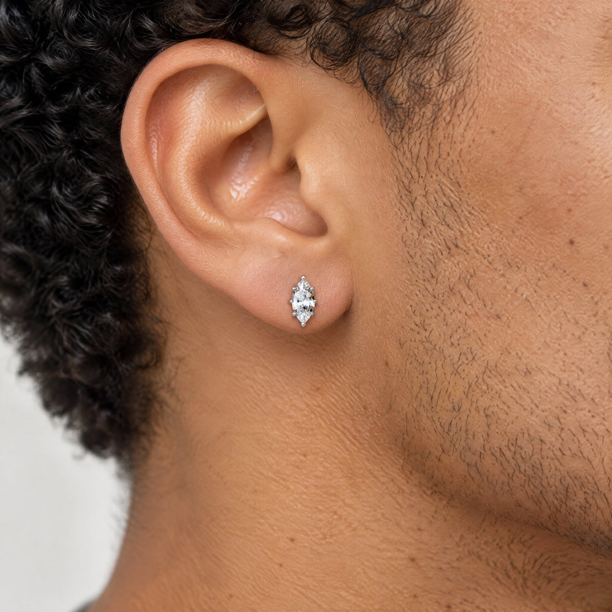 Marquise stud earring worn on the earlobe