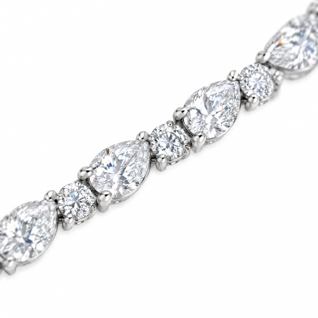 Close-up of alternating pear-cut and round moissanite stones