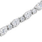 Close-up of alternating pear-cut and round moissanite stones