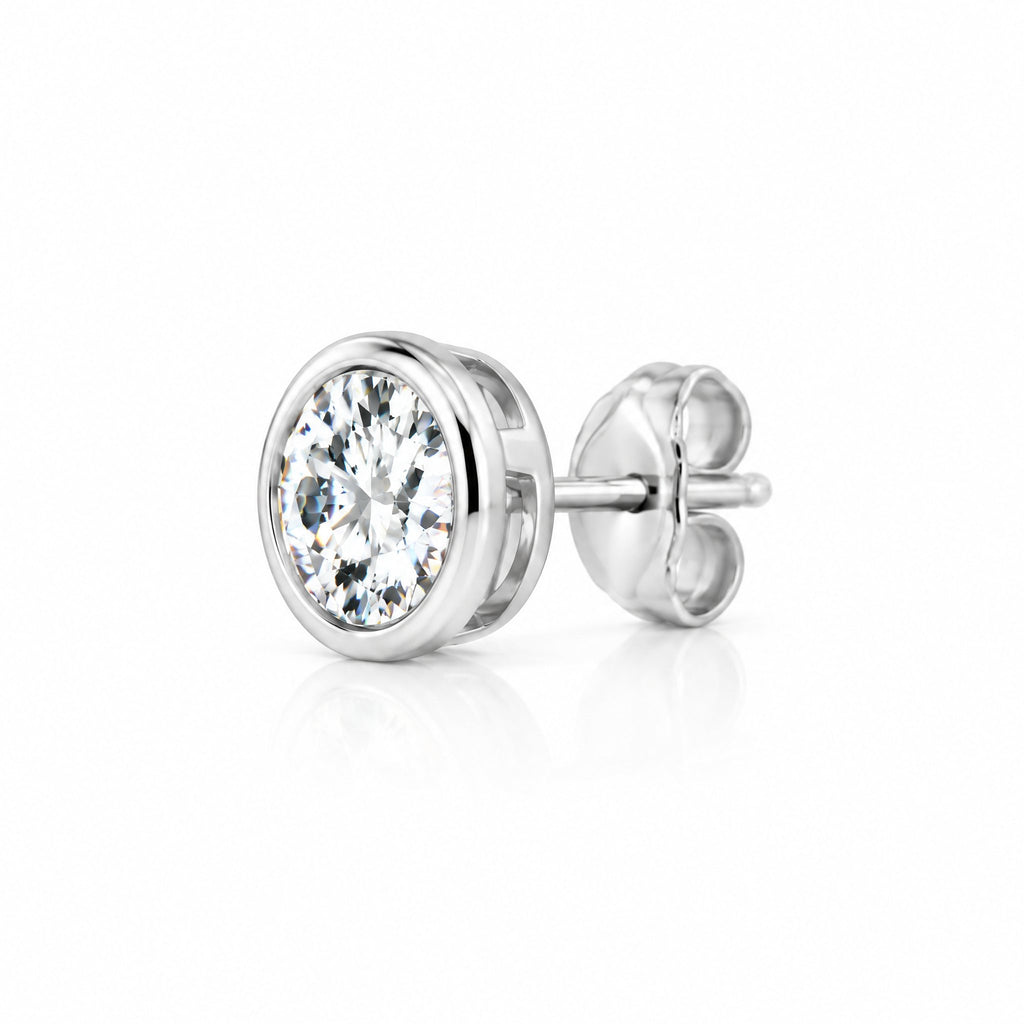 Round moissanite solitaire stud earring in a bezel setting, side angle