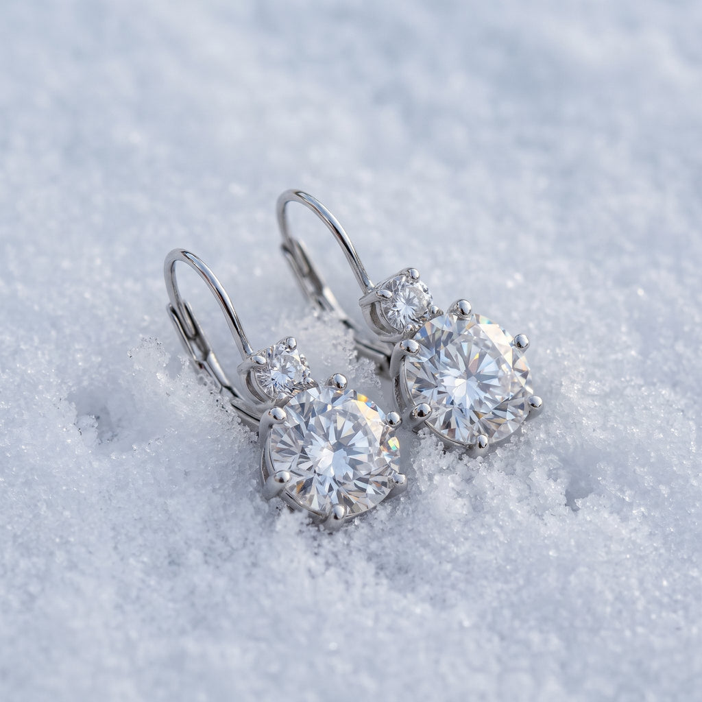 Pair of drop earrings on snow