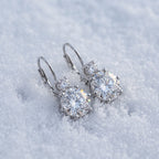Pair of drop earrings on snow