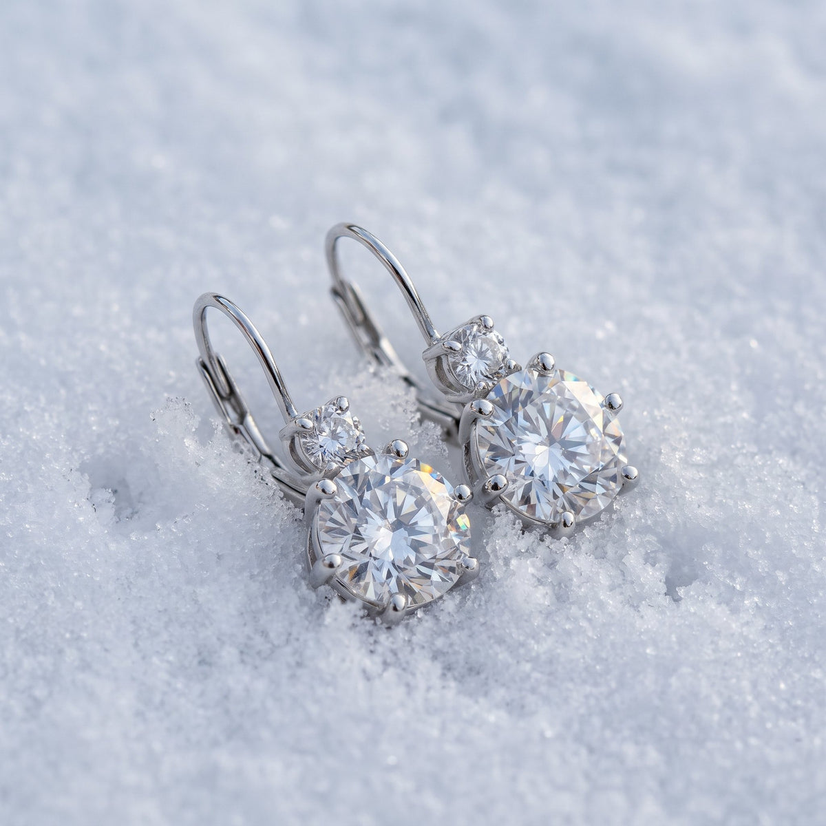 Pair of drop earrings on snow