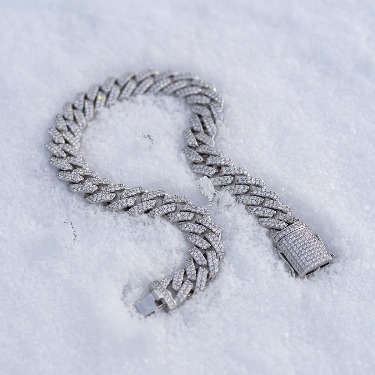 8mm Cuban link bracelet curved across fresh snow