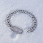 10mm iced Cuban link bracelet resting on fresh snow
