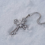 Statement cross pendant lying on snow