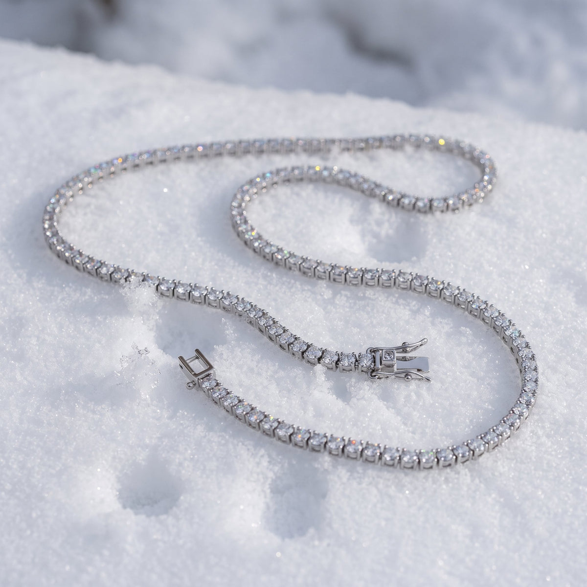 3mm tennis chain draped across snow