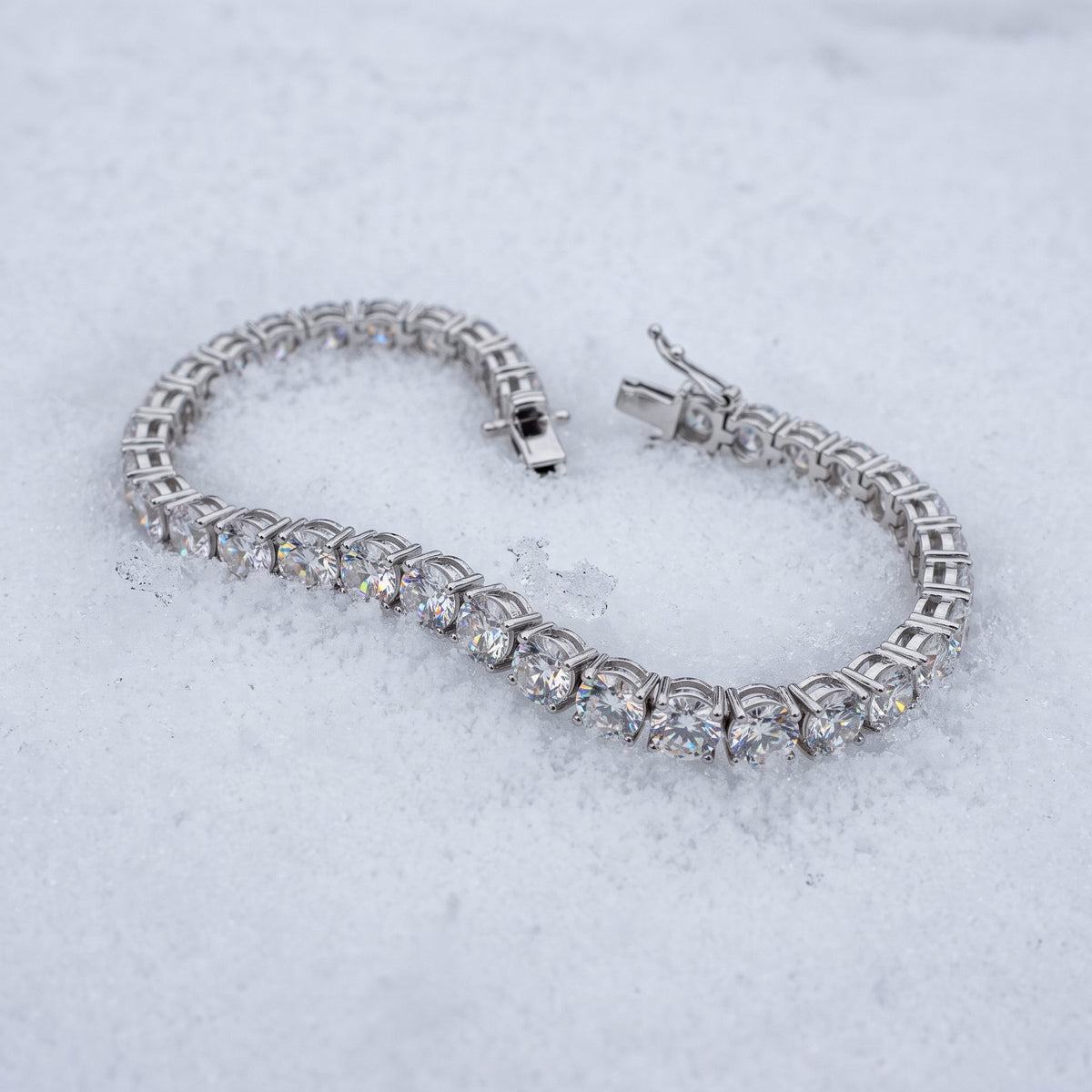 5mm tennis bracelet lying open on snow