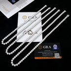 Tennis chains laid on a black surface with GRA moissanite report cards